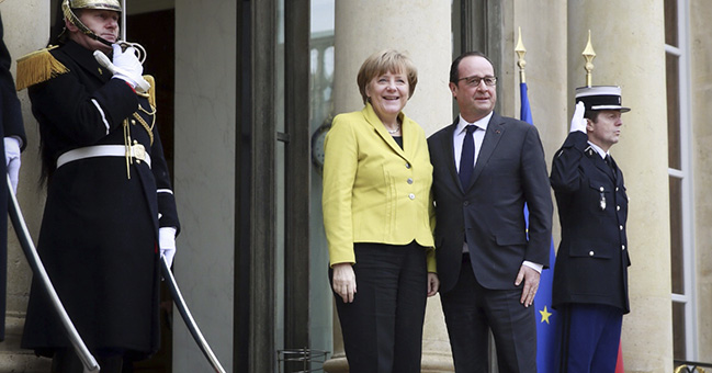 The French President François Hollande welcomes Chancellor Angela Merkel at the Elysee Palace.