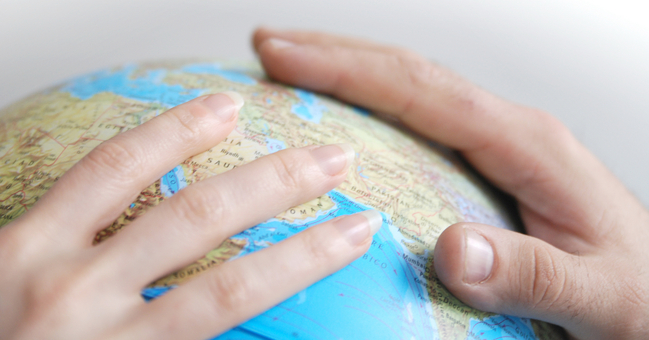 Hands on a globe